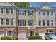 Charming townhome with brick accents, a one car garage and manicured landscaping at 3014 Castleberry Ct, Charlotte, NC 28209