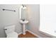 Small half bathroom featuring a pedestal sink, wood flooring, and natural light at 3014 Castleberry Ct, Charlotte, NC 28209