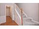 Elegant foyer with wood floors, wainscoting and a staircase with carpeted steps at 3014 Castleberry Ct, Charlotte, NC 28209