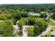An aerial view of a quaint neighborhood showcases lush greenery and charming homes at 310 S Jacob St, Cherryville, NC 28021