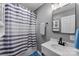 Well-lit bathroom featuring a vanity with modern fixtures and a shower with a stylish curtain at 310 S Jacob St, Cherryville, NC 28021