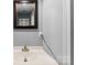Bathroom featuring a white sink, framed mirror, light gray walls, and white trim at 310 S Jacob St, Cherryville, NC 28021
