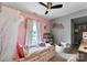 Charming bedroom featuring pink walls, a crib with a canopy, and soft lighting at 310 S Jacob St, Cherryville, NC 28021