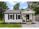 Charming home featuring a metal roof, black-framed windows, and a cozy front porch with stone steps at 310 S Jacob St, Cherryville, NC 28021