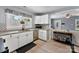 Bright kitchen features stainless steel appliances, white cabinets, and hard wood floors at 310 S Jacob St, Cherryville, NC 28021