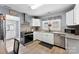 Kitchen features granite counters, stainless steel appliances, and white cabinets at 310 S Jacob St, Cherryville, NC 28021