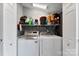 A laundry room with a white washer and dryer, storage shelves, and white doors is shown at 310 S Jacob St, Cherryville, NC 28021