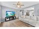 Inviting living room boasts hardwood floors, light gray walls, a ceiling fan, and a comfortable sofa at 310 S Jacob St, Cherryville, NC 28021