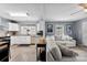 Open floor plan featuring living room, kitchen with white cabinets, and hard wood floors at 310 S Jacob St, Cherryville, NC 28021
