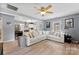 Cozy living room with hardwood floors, a large sectional sofa, and open access to the modern kitchen at 310 S Jacob St, Cherryville, NC 28021