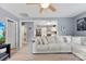Bright living room showcasing hardwood floors, a neutral sofa, and an open layout to the kitchen at 310 S Jacob St, Cherryville, NC 28021
