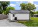 Exterior view of outbuilding features a white siding, black roof, and adjacent gravel driveway at 310 S Jacob St, Cherryville, NC 28021