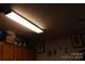 Brightly-lit basement with wooden cabinets, framed art and a white door at 3241 Reid Ave, Charlotte, NC 28208