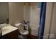 Bathroom with a tub-shower, vanity, and convenient storage shelves at 3241 Reid Ave, Charlotte, NC 28208