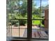 View of brick patio and backyard through a large window with a view of nature at 3408 Oak Tree Trl, Matthews, NC 28105