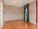 Charming dining room featuring hardwood floors, chandelier, and elegant wallpaper at 3408 Oak Tree Trl, Matthews, NC 28105
