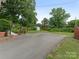 Long paved driveway provides ample parking space and leads to a beautifully landscaped property at 3408 Oak Tree Trl, Matthews, NC 28105