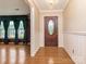 Elegant foyer with hardwood floors, chandelier, and decorative wall trim at 3408 Oak Tree Trl, Matthews, NC 28105