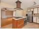 Bright kitchen featuring a center island with cooktop and a stainless steel refrigerator at 3408 Oak Tree Trl, Matthews, NC 28105