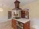 Open kitchen design with island cooktop and range hood near the dining area at 3408 Oak Tree Trl, Matthews, NC 28105