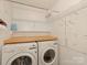 A functional laundry room with washer, dryer, and overhead storage and hanging rack at 3408 Oak Tree Trl, Matthews, NC 28105
