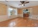 Open-concept living room with hardwood floors and a view into the kitchen at 3408 Oak Tree Trl, Matthews, NC 28105