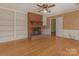 Charming living room with built-in shelving, a fireplace, and hardwood floors at 3408 Oak Tree Trl, Matthews, NC 28105