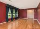 Large living room featuring hardwood floors, elegant curtains, and plenty of space at 3408 Oak Tree Trl, Matthews, NC 28105