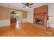 Cozy living room featuring a brick fireplace and an adjoining kitchen area at 3408 Oak Tree Trl, Matthews, NC 28105