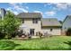 View of the backyard with lush green grass and a patio with a seating area at 3702 Brookstone Trl, Indian Trail, NC 28079