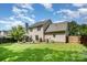 Spacious backyard featuring a brick patio, lush lawn, and mature trees at 3702 Brookstone Trl, Indian Trail, NC 28079