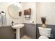 Charming half-bathroom with stylish wallpaper, pedestal sink, and decorative wall cabinet at 3702 Brookstone Trl, Indian Trail, NC 28079