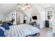 Attic bedroom with wood flooring, ceiling fan, and a grey and white comforter at 3702 Brookstone Trl, Indian Trail, NC 28079