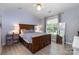 Inviting bedroom with vaulted ceiling, wood-framed bed, and ample natural light at 3702 Brookstone Trl, Indian Trail, NC 28079