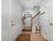 Inviting entryway featuring hardwood floors, a staircase with wooden banister, and a unique cat climber at 3702 Brookstone Trl, Indian Trail, NC 28079