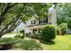 Traditional two-story home with a manicured lawn, a welcoming front porch, and a charming curb appeal with mature trees at 3702 Brookstone Trl, Indian Trail, NC 28079