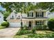Charming two-story home featuring a welcoming front porch and attached two-car garage with a beautifully landscaped front yard at 3702 Brookstone Trl, Indian Trail, NC 28079