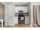 Modern kitchen featuring white cabinets, stainless steel appliances, and light wood flooring at 3702 Brookstone Trl, Indian Trail, NC 28079