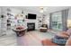 Cozy living room features a fireplace, built-in shelving, and a ceiling fan for added comfort at 3702 Brookstone Trl, Indian Trail, NC 28079