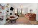 Open living room with a fireplace, built-in shelving, and hardwood floors for a modern and comfortable living space at 3702 Brookstone Trl, Indian Trail, NC 28079