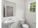 Powder bath with white fixtures, hard surface floor, and a window at 510 3Rd St, Salisbury, NC 28144