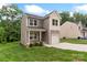 Charming two-story home featuring a gray and white exterior, attached garage, long driveway, and lawn at 510 3Rd St, Salisbury, NC 28144