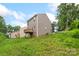 Exterior view of the home, showing the siding, basement access and a small deck at 510 3Rd St, Salisbury, NC 28144