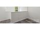Hallway with wood-look floors and a window offering natural light at 510 3Rd St, Salisbury, NC 28144