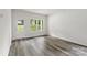 Spacious living room with large windows and a door to the backyard providing ample natural light at 510 3Rd St, Salisbury, NC 28144