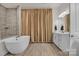 Luxurious bathroom featuring a freestanding tub, tiled shower, and elegant vanity at 513 Meadow Ridge Dr, Belmont, NC 28012