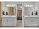 Dual vanity bathroom with modern fixtures and a doorway leading to the bedroom at 513 Meadow Ridge Dr, Belmont, NC 28012