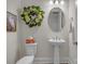 Charming powder room with pedestal sink, decorative wreath, and framed art at 513 Meadow Ridge Dr, Belmont, NC 28012