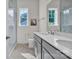 Bright bathroom with double sink vanity, marble floors, and glass enclosed shower at 513 Meadow Ridge Dr, Belmont, NC 28012