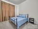 Comfortable bedroom featuring a metal frame bed and neutral tones at 513 Meadow Ridge Dr, Belmont, NC 28012